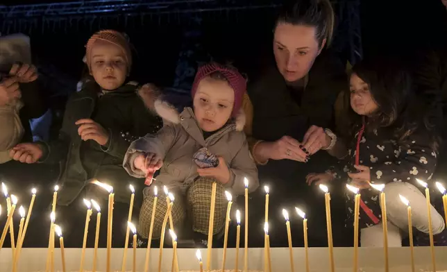 People light candles for the victims of the Wednesday's shooting rampage in Cetinje, in Podogrica, Montenegro, Thursday, Jan. 2, 2025. (AP Photo/Risto Bozovic)