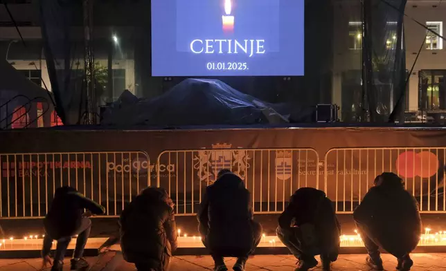 People light candles for the victims of the yesterday's shooting rampage in Cetinje, in Podogrica, Montenegro, Thursday, Jan. 2, 2025. (AP Photo/Risto Bozovic)