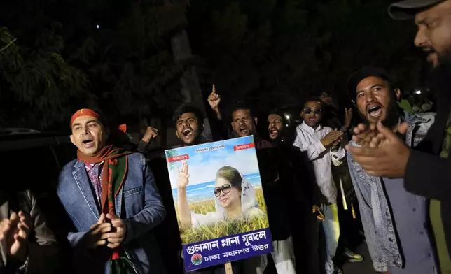 Supporters of Bangladesh's ailing former Prime Minister Khaleda Zia shout slogans before Zia left Dhaka, Bangladesh, to travel to London for medical treatment, Tuesday, Jan. 7, 2025. (AP Photo/Mahmud Hossain Opu)