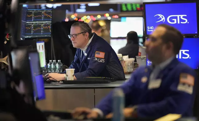 Traders work on the floor at the New York Stock Exchange in New York's Financial District Thursday, Jan. 2, 2025. (AP Photo/Seth Wenig)