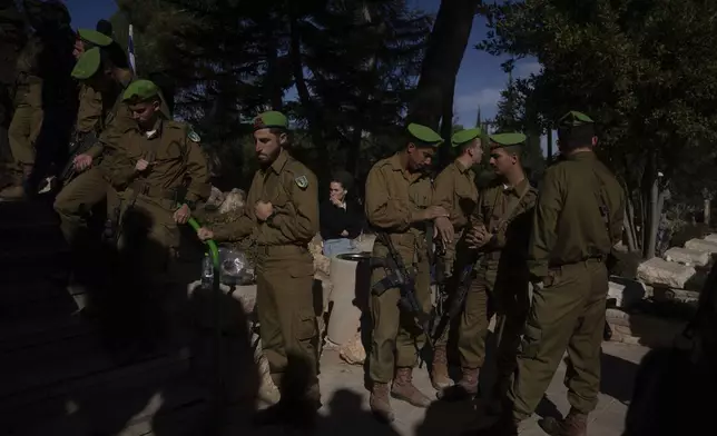 Israeli soldiers attend the funeral of 1st Sgt. Matityahu Ya'akov Perel, who was killed in a battle in the Gaza Strip, at the Mount Herzl military cemetery in Jerusalem, Thursday, Jan. 9, 2025. (AP Photo/Ohad Zwigenberg)