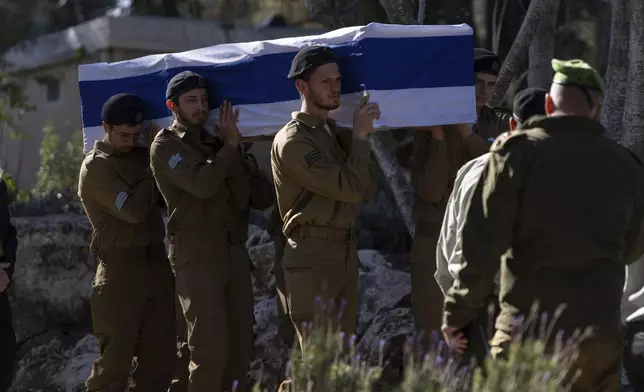 Israeli soldiers and relatives carry the flag-draped casket of 1st Sgt. Matityahu Ya'akov Perel, who was killed in combat in the Gaza Strip, during his funeral at the Mount Herzl military cemetery in Jerusalem, Israel, Thursday, Jan. 9, 2025. (AP Photo/Ohad Zwigenberg)