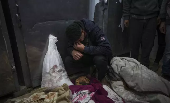 Kareem Al-Dabaji mourns his brother Anas Al-Dabaji, who was killed in an Israeli airstrike that hit an apartment in Deir Al-Balah, at Al-Aqsa Hospital morgue in Deir Al-Balah, Gaza, Thursday, Jan. 9, 2025. (AP Photo/Abdel Kareem Hana)