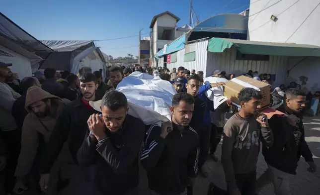 Palestinians carry the bodies of their relatives killed in the Israeli bombardment in Deir al-Balah, Gaza, Thursday, Jan. 9, 2025. (AP Photo/Abdel Kareem Hana)