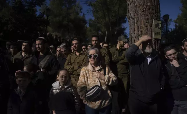 Mourners attend the funeral of Israeli soldier 1st Matityahu Ya'akov Perel, who was killed in a battle in the Gaza Strip, at the Mount Herzl military cemetery in Jerusalem, Israel, Thursday, Jan. 9, 2025. (AP Photo/Ohad Zwigenberg)