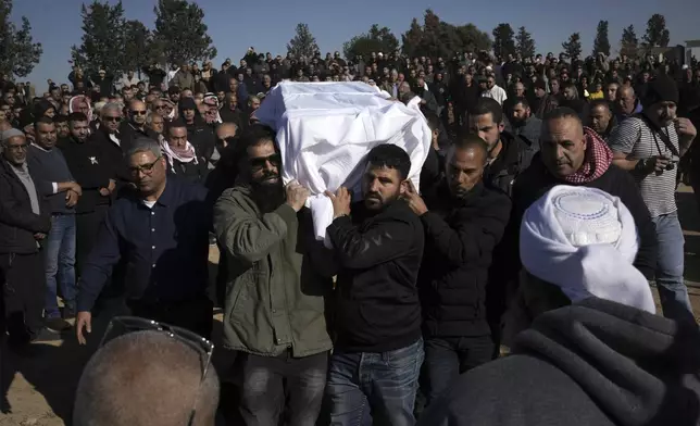 Members of the Bedouin community carry the body of Yosef Al Zaydani, who was in Hamas captivity in the Gaza Strip, a day after the Israeli army said his body was recovered in an underground tunnel in southern Gaza, during his funeral in Rahat, southern Israel, Thursday, Jan. 9, 2025. (AP Photo/Mahmoud Illean)