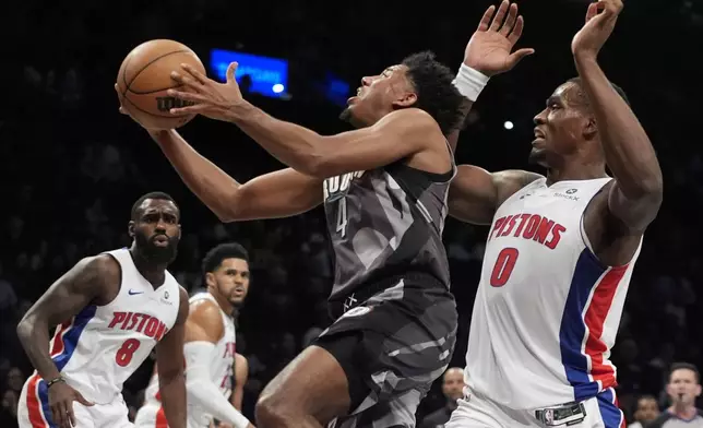 Brooklyn Nets' Reece Beekman (4) drives past Detroit Pistons' Jalen Duren (0) as Tim Hardaway Jr. (8) watches during the first half of an NBA basketball game, Wednesday, Jan. 8, 2025, in New York. (AP Photo/Frank Franklin II)