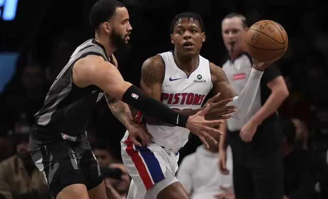 Detroit Pistons' Marcus Sasser (25) passes away from Brooklyn Nets' Tyrese Martin (13) during the first half of an NBA basketball game, Wednesday, Jan. 8, 2025, in New York. (AP Photo/Frank Franklin II)