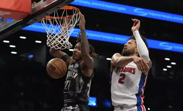 Brooklyn Nets' Noah Clowney (21) drives past Detroit Pistons' Cade Cunningham (2) during the first half of an NBA basketball game, Wednesday, Jan. 8, 2025, in New York. (AP Photo/Frank Franklin II)