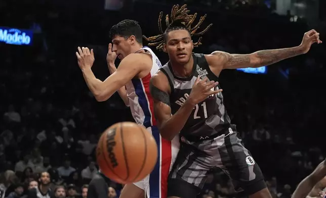 Detroit Pistons' Simone Fontecchio, left, fights for control of the ball with Brooklyn Nets' Noah Clowney (21) during the first half of an NBA basketball game, Wednesday, Jan. 8, 2025, in New York. (AP Photo/Frank Franklin II)