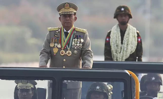 FILE - Myanmar military leader Senior Gen. Min Aung Hlaing, left, head of the military council, inspects officers during a parade to commemorate Myanmar's 78th Armed Forces Day in Naypyitaw, Myanmar, on March 27, 2023. (AP Photo/Aung Shine Oo)