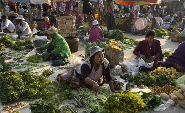 Vendors selling groceries wait for customers at a local market Saturday, Feb. 1, 2025, in Naypyitaw, Myanmar. (AP Photo/Aung Shine Oo)