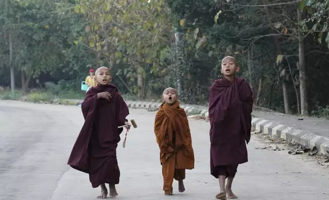 Buddhist novice monks shout to collect their morning alms Saturday, Feb. 1, 2025, in Naypyitaw, Myanmar. (AP Photo/Aung Shine Oo)