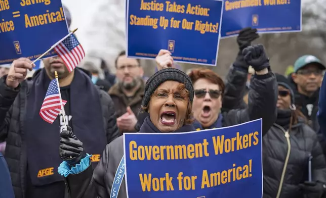 Sona Anderson of San Diego, center, shouts her support for civil service workers as activists protest the policies of President Donald Trump and Elon Musk outside the Capitol in Washington, Tuesday, Feb. 11, 2025. (AP Photo/J. Scott Applewhite)