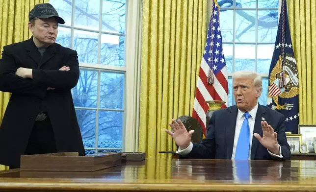 President Donald Trump speaks with reporters as Elon Musk listens in the Oval Office at the White House, Tuesday, Feb. 11, 2025, in Washington. (Photo/Alex Brandon)