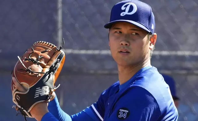 Los Angeles Dodgers two-way player Shohei Ohtani (17) works out during spring training baseball practice, Saturday, Feb. 15, 2025, in Phoenix. (AP Photo/Ashley Landis)