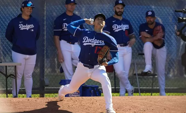 Los Angeles Dodgers two-way player Shohei Ohtani (17) works out during spring training baseball practice, Saturday, Feb. 15, 2025, in Phoenix. (AP Photo/Ashley Landis)