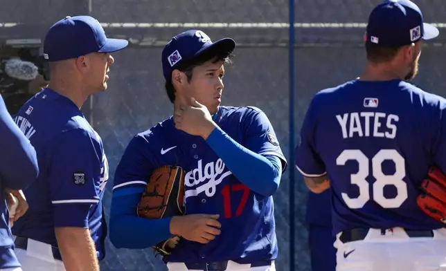 Los Angeles Dodgers two-way player Shohei Ohtani (17) works out during spring training baseball practice, Saturday, Feb. 15, 2025, in Phoenix. (AP Photo/Ashley Landis)