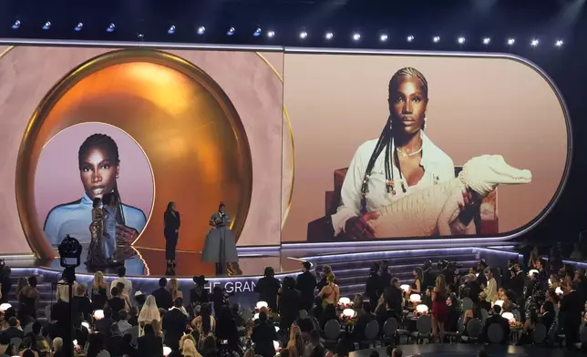 Doechii, center, accepts the award for best rap album for "Alligator Bites Never Heal" during the 67th annual Grammy Awards on Sunday, Feb. 2, 2025, in Los Angeles. Cardi B, far left, and Celesia Moore looks on from left(AP Photo/Chris Pizzello)