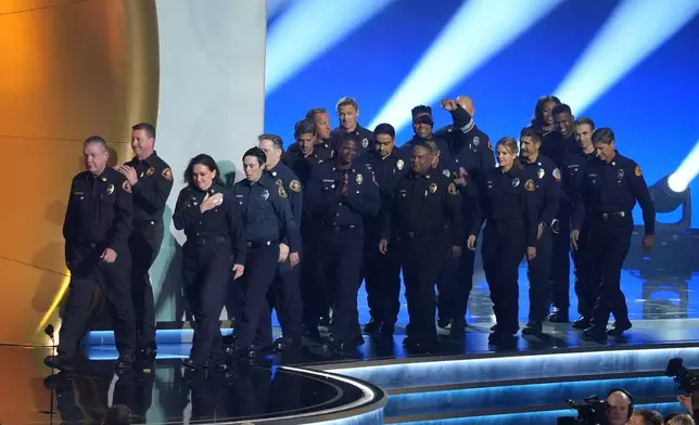 Members of the County of Los Angeles Fire Department present the award for album of the year during the 67th annual Grammy Awards on Sunday, Feb. 2, 2025, in Los Angeles. (AP Photo/Chris Pizzello)