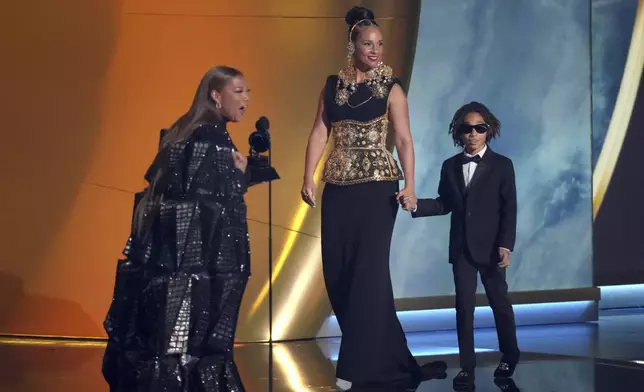Queen Latifah, left, presents the Dr. Dre Global Impact Award to Alicia Keys during the 67th annual Grammy Awards on Sunday, Feb. 2, 2025, in Los Angeles. Genesis Ali Dean looks on from right.(AP Photo/Chris Pizzello)