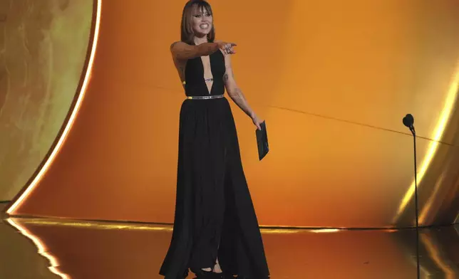 Miley Cyrus presents the award for record of the year during the 67th annual Grammy Awards on Sunday, Feb. 2, 2025, in Los Angeles. (AP Photo/Chris Pizzello)