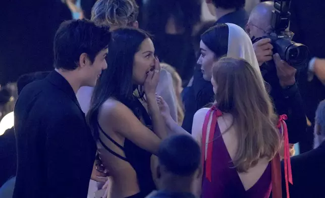 Olivia Rodrigo, second from left, and Gracie Abrams speak in the audience during the 67th annual Grammy Awards on Sunday, Feb. 2, 2025, in Los Angeles. (AP Photo/Chris Pizzello)