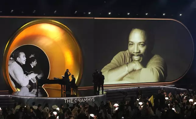 Will Smith, left, speaks while Herbie Hancock plays the piano during the 67th annual Grammy Awards on Sunday, Feb. 2, 2025, in Los Angeles. (AP Photo/Chris Pizzello)