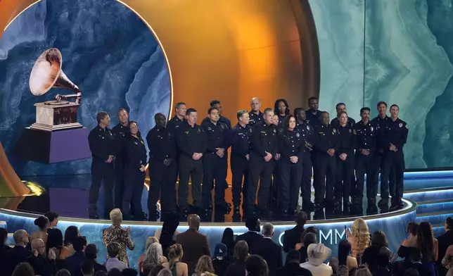 Members of the County of Los Angeles Fire Department present the award for album of the year during the 67th annual Grammy Awards on Sunday, Feb. 2, 2025, in Los Angeles. (AP Photo/Chris Pizzello)