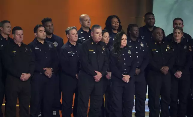 Members of the County of Los Angeles Fire Department present the award for album of the year during the 67th annual Grammy Awards on Sunday, Feb. 2, 2025, in Los Angeles. (AP Photo/Chris Pizzello)