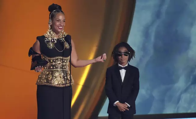 Alicia Keys accepts the Dr. Dre Global Impact Award during the 67th annual Grammy Awards on Sunday, Feb. 2, 2025, in Los Angeles. Genesis Ali Dean looks on from right.(AP Photo/Chris Pizzello)