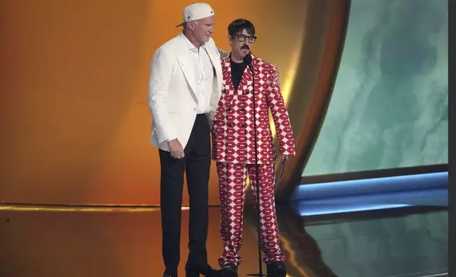 Chad Smith, left, and Anthony Kiedis of Red Hot Chili Peppers presents the award for best pop vocal album during the 67th annual Grammy Awards on Sunday, Feb. 2, 2025, in Los Angeles. (AP Photo/Chris Pizzello)