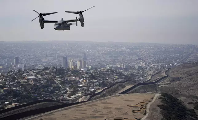 A U.S. Marine Osprey is flown over the border Friday, Jan. 31, 2025, near San Diego. (AP Photo/Jae C. Hong)