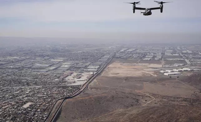 A U.S. Marine Osprey is flown over the border Friday, Jan. 31, 2025, near San Diego. (AP Photo/Jae C. Hong)