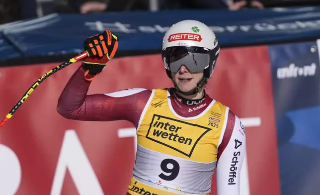 Austria's Mirjam Puchner celebrates at the finish area of a women's downhill race, at the Alpine Ski World Championships, in Saalbach-Hinterglemm, Austria, Saturday, Feb. 8, 2025. (AP Photo/Giovanni Auletta)
