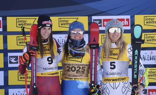 United States' Breezy Johnson, center, winner of a gold medal in a women's downhill race, celebrates on the podium with silver medalist Austria's Mirjam Puchner, left, and bronze medalist Czech Republic's Ester Ledecka, at the Alpine Ski World Championships, in Saalbach-Hinterglemm, Austria, Saturday, Feb. 8, 2025. (AP Photo/Giovanni Auletta)