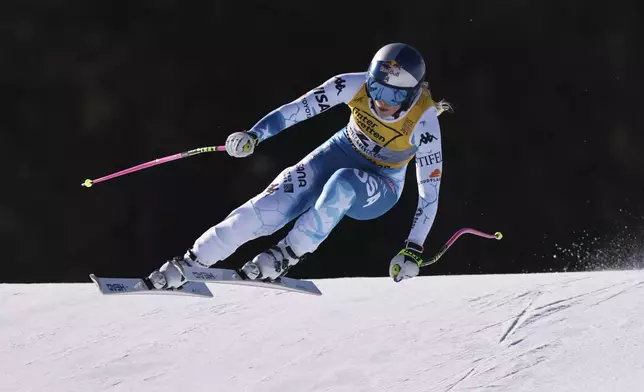 United States' Lindsey Vonn speeds down the course during a women's downhill race, at the Alpine Ski World Championships, in Saalbach-Hinterglemm, Austria, Saturday, Feb. 8, 2025. (AP Photo/Marco Trovati)