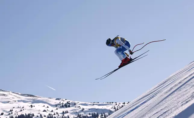United States' Breezy Johnson is airborne during a women's downhill race, at the Alpine Ski World Championships, in Saalbach-Hinterglemm, Austria, Saturday, Feb. 8, 2025. (AP Photo/Gabriele Facciotti)