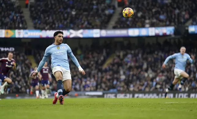 Manchester City's Omar Marmoush scores their side's first goal of the game during the Premier League match between Manchester City and Newcastle at the Etihad Stadium, Manchester, England, Saturday Feb. 15, 2025. (Martin Rickett/PA via AP)