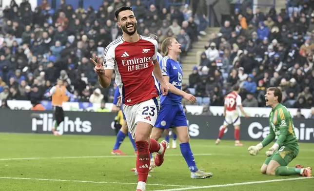 Arsenal's Mikel Merino, center, celebrates after scoring his side's opening goal during the English Premier League soccer match between Leicester City and Arsenal at King Power stadium in Leicester, England, Saturday, Feb. 15, 2025. (AP Photo/Rui Vieira)