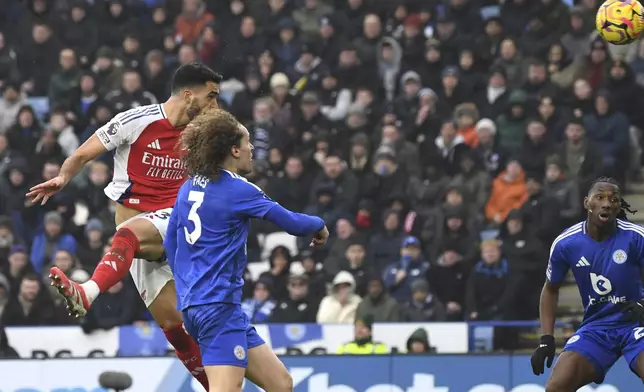 Arsenal's Mikel Merino, left, scores his side's opening goal during the English Premier League soccer match between Leicester City and Arsenal at King Power stadium in Leicester, England, Saturday, Feb. 15, 2025. (AP Photo/Rui Vieira)