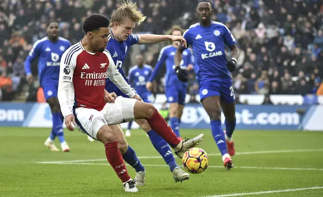 Arsenal's Ethan Nwaneri, left, challenges for the ball with Leicester's Victor Kristiansen during the English Premier League soccer match between Leicester City and Arsenal at King Power stadium in Leicester, England, Saturday, Feb. 15, 2025. (AP Photo/Rui Vieira)