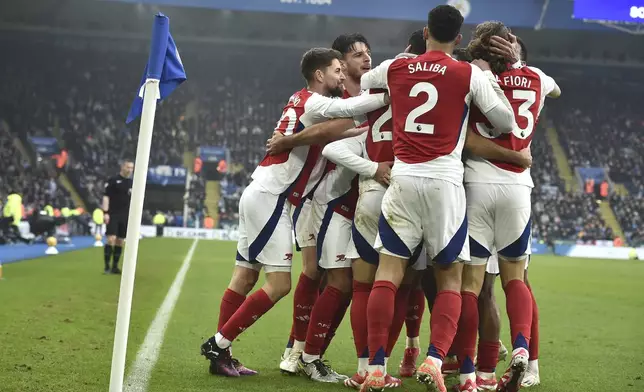 Arsenal players celebrate after Arsenal's Mikel Merino scored his side's opening goal during the English Premier League soccer match between Leicester City and Arsenal at King Power stadium in Leicester, England, Saturday, Feb. 15, 2025. (AP Photo/Rui Vieira)