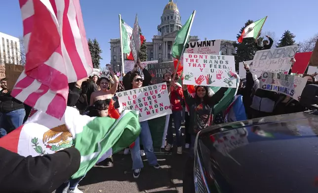 Participants stop traffic on Lincoln Street during a political protest outside the State Capitol Wednesday, Feb. 5, 2025, in Denver. (AP Photo/David Zalubowski)