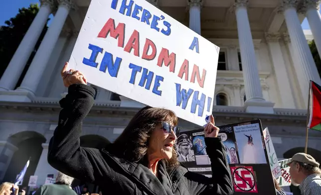 Elaine Torok joins several hundred demonstrators outside the California State Capitol to protest against President Donald Trump on Wednesday, Feb. 5, 2025, in Sacramento, Calif. (AP Photo/Noah Berger)