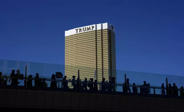 Demonstrators march to protest against the Trump administration near the Trump International Hotel along the Las Vegas Strip, Wednesday, Feb. 5, 2025, in Las Vegas. (AP Photo/John Locher)
