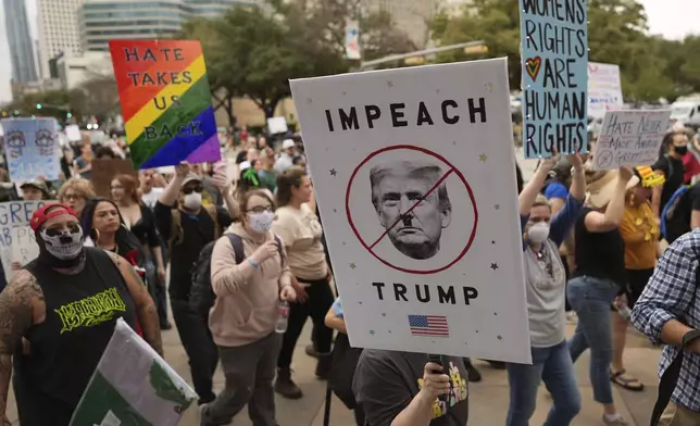 Protesters march to the Texas Capitol, Wednesday, Feb. 5, 2025, in Austin, Texas. (AP Photo/Eric Gay)