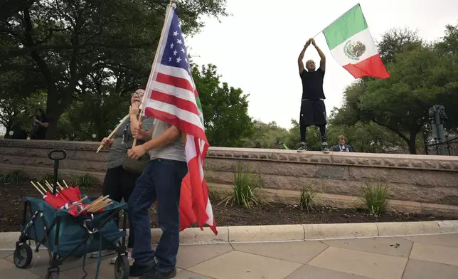 Protesters carrying flags gather on steps of the Texas Capitol, Wednesday, Feb. 5, 2025, in Austin, Texas. (AP Photo/Eric Gay)