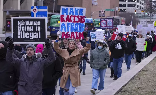 Protestors march around the Statehouse in Indianapolis, Wednesday, Feb. 5, 2025 during a protest rally against Project 2025. (AP Photo/Michael Conroy)