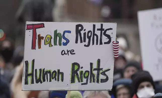 A sign is held up during a protest outside the Wisconsin Capitol Wednesday, Feb. 5, 2025, in Madison, Wis. (AP Photo/Morry Gash)